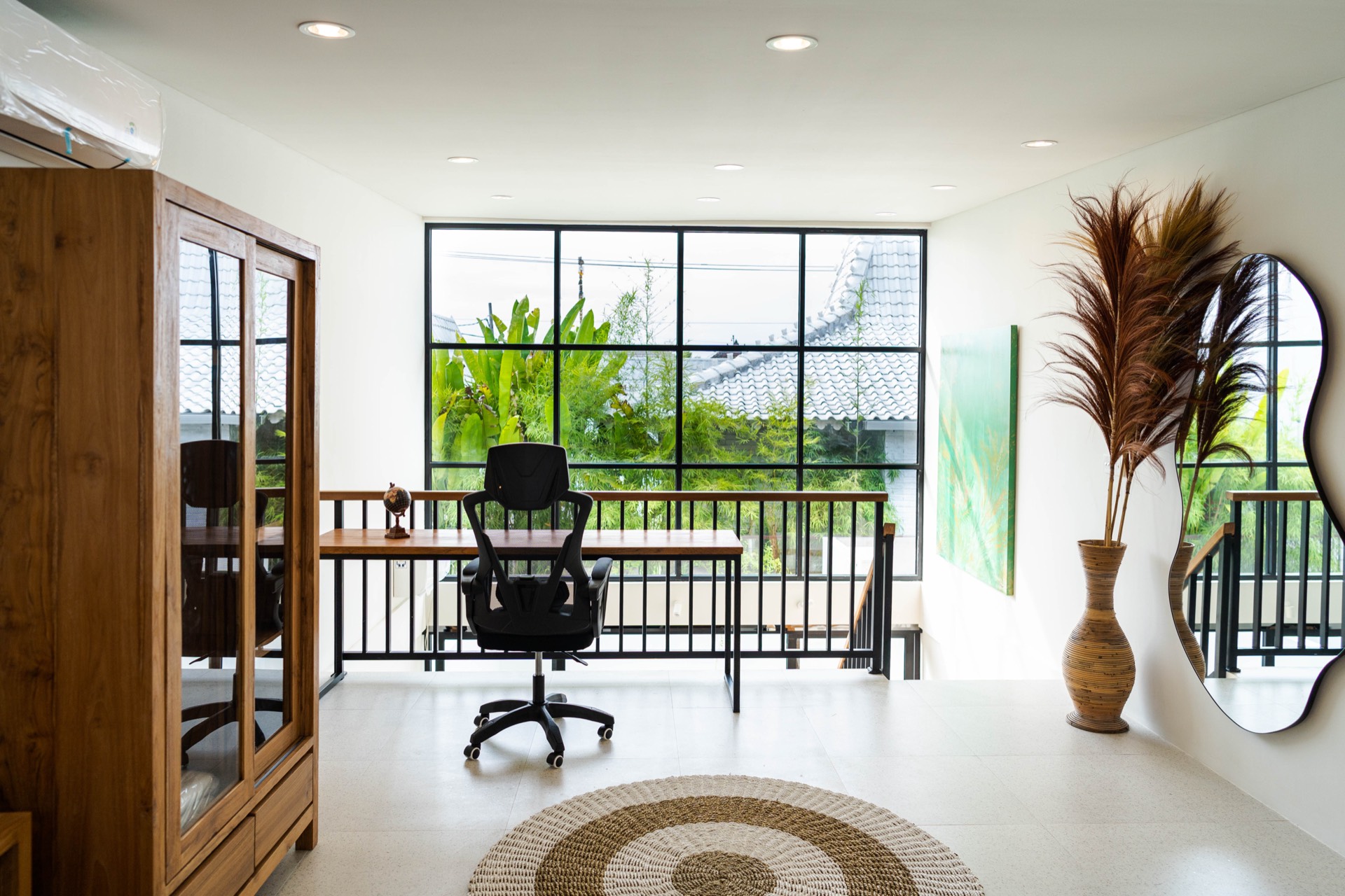 Office area with mirror and palm vase